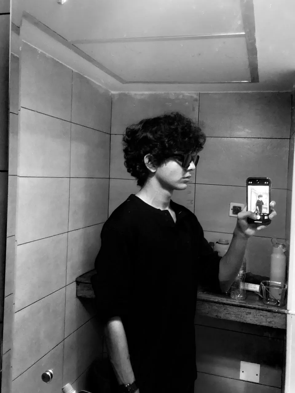 Black-and-white mirror selfie of Aayan in sunglasses and a black shirt